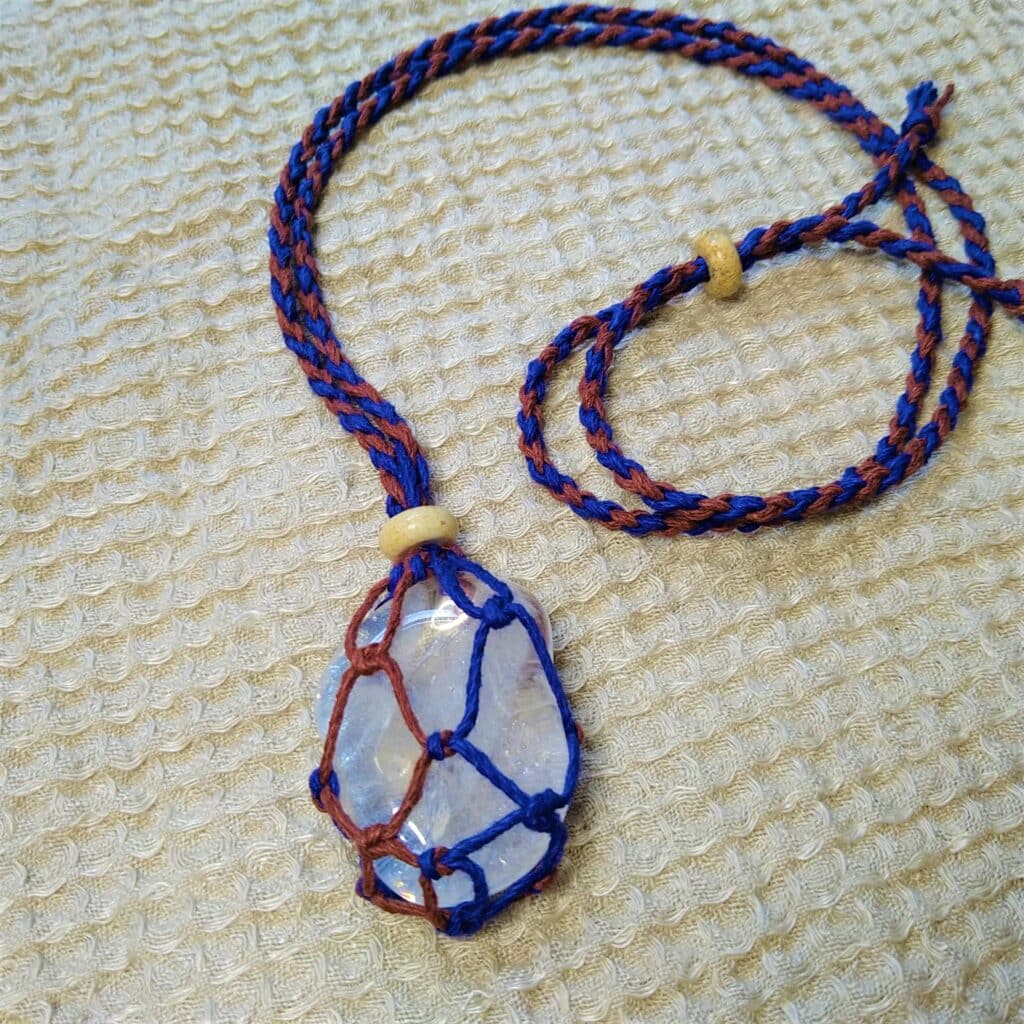 Handmade crystal necklace. Macrame pendant with blue and brown cord. Fashion jewelry.